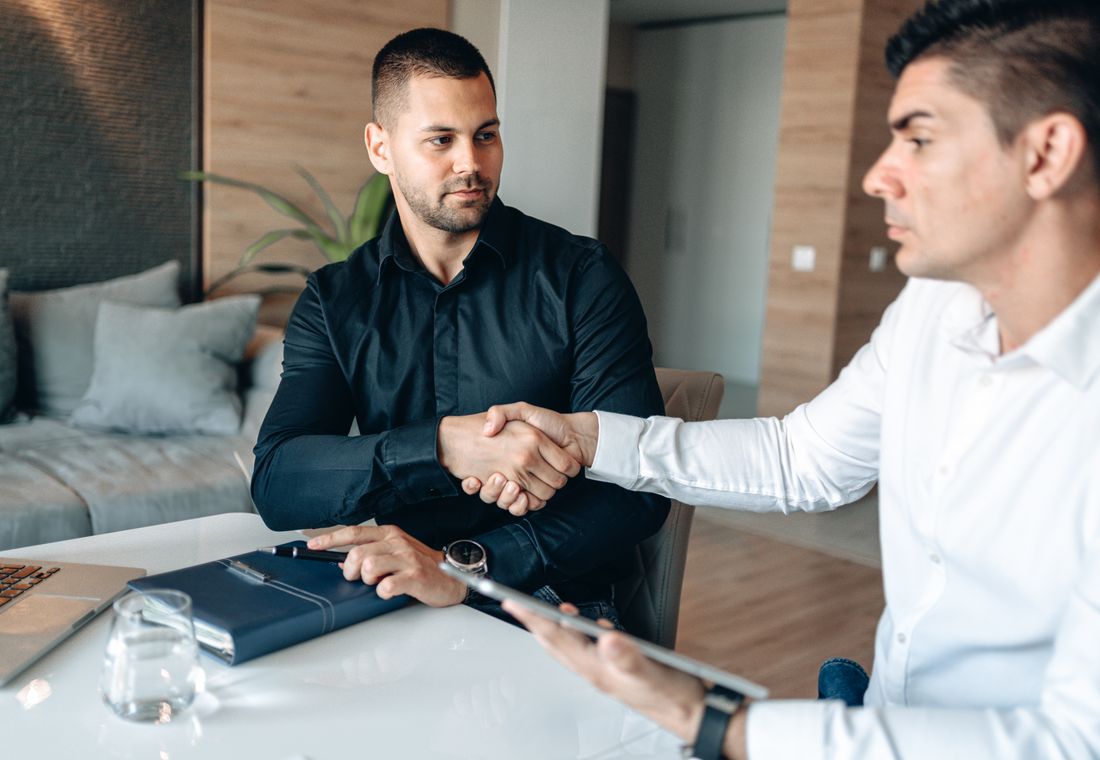 Two people shaking hands after a meeting