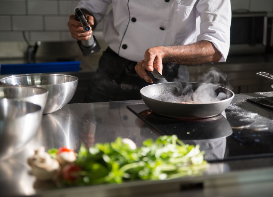 A chef cooking in a restaurant kitchen
