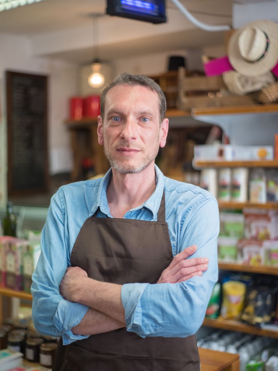 A shop owner standing in his store
